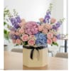 This vibrant one-sided arrangement features soft pink hydrangeas, &amp; vibrant blue hydrangeas