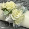 This elegant corsage is crafted from delicate white rose flowers and adorned