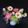 Pink and cream mixed bouquet in a white vase