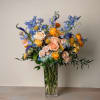 A vibrant tribute to coastal summer warmth, this arrangement features a rich