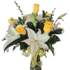 Bright yellow roses adorned with glorious white lilies and rich greenery for