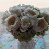 Creamy white roses gathered into a compact, rounded bouquet create an immediate