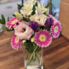 A tall, airy spring vase that reads like a fresh garden in