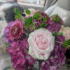 A pale pink rose takes center stage in this cube arrangement, its