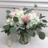 Pink roses and white hydrangeas in a glass vase