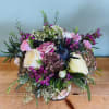 A lush, garden-like mixed bouquet that feels both romantic and slightly rustic-perfect