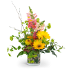 Golden Hour is a vibrant and full flower arrangement featuring greenery surrounding