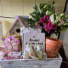 A lively mixed bouquet paired with thoughtful garden-themed gifts makes this wooden