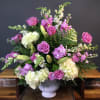 Soft purple roses, creamy white hydrangeas, white lilies, and delicate lavender stock