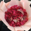 Bouquet of pink and red roses with butterfly decorations and a tiara