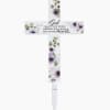 Decorative memorial cross with purple flowers and a stake