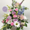 Celebrate the beauty of motherhood with this charming garden-style arrangement, bursting with