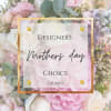 Pink and white floral arrangement with a Mother's Day sign