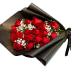 Bouquet of red roses wrapped in black paper with white baby's breath