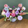 A whimsical floral arrangement with in season blooms. 