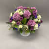 Lavender seasonal flowers in a small white glass vase. Perfect for any