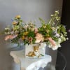 This beautiful flower arrangement of fresh mixed seasonal blooms is made by