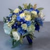 Cream-white roses paired with vivid blue roses and blue-dyed accent blooms give