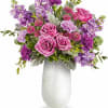 Lush pink roses and soft lavender stock form the heart of this