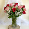 Bouquet of red and pink roses in a clear glass vase