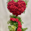 Heart-shaped red rose arrangement in a wooden box