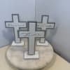 Three decorative cross signs on a round marble base