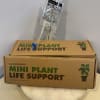 Plant care kit with a clear water pouch and cardboard box