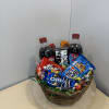 Basket of soda bottles and assorted candy and cookies