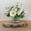 White and blush flower arrangement in a glass vase