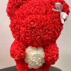 Red teddy bear made of roses with a white rose heart on its chest