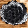 Round bouquet of black glitter roses wrapped in black and white patterned paper