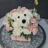 Dense pastel arrangement of white carnations, pink spray roses, white alstroemeria, and