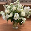 Extravagant and clean floral arrangement filled with unique white blooms. 
(Please note: