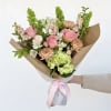 Pink roses and peach mums are the focus of this hand-tied bouquet