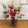 Pale pink roses and stargazer lilies with fragrant magenta stock, green hypericum