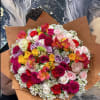 Large bouquet of multicolored roses with brown paper wrapping