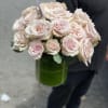 Bouquet of pale pink roses in a green glass vase