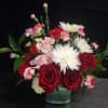 Deep red roses and pale pink roses meet white spider chrysanthemums in