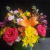 A bold orange lily crowns this mixed bouquet, surrounded by bright pink