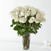 White roses arranged in a clear glass vase
