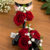 A romantic set featuring rich red roses accented with delicate baby&rsquo;s breath