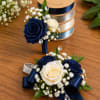 A sophisticated set featuring deep navy and ivory roses accented with baby&rsquo;s