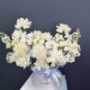 A cloud of white blooms-roses, phalaenopsis orchids, peony-like blossoms, carnations and tall