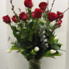 Red roses and white tulips in a clear glass vase