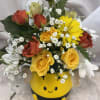 A whimisical Bee vase brightens the day with pretty yellow &amp; other