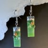 Vibrant rectangular green glass drops catch the light in these handmade dangle