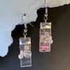Iridescent rectangular resin pendants catch the light with soft swirls of pink