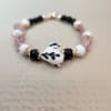 With Rose Gold accents this beautiful Petite Black and White Lampwork Heart