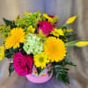 Bright hot-pink roses and sunny yellow gerbera daisies meet pale green hydrangea