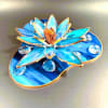 A marbled blue-and-teal stained-glass lotus brings a quiet, reflective moment to any